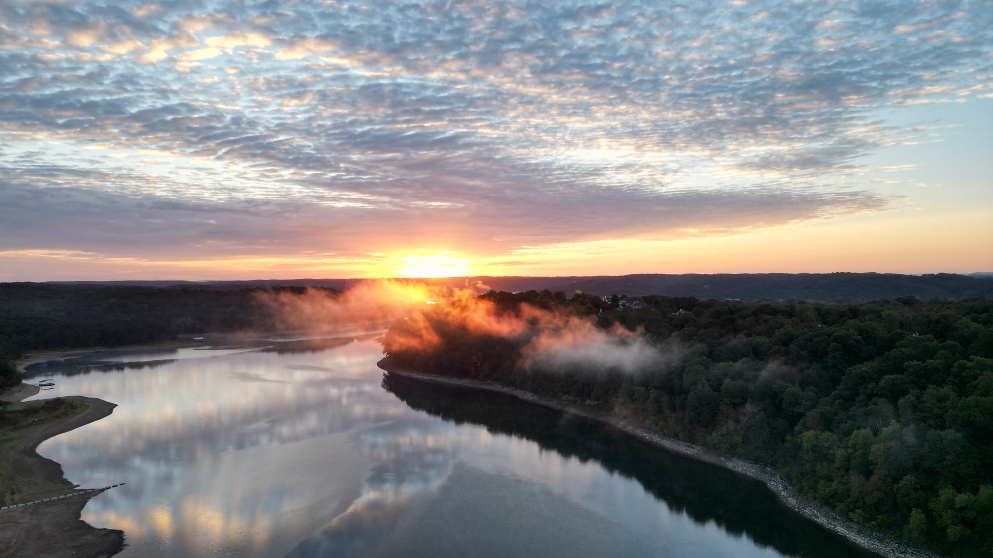 Sunrise burning off the mist over Beaver Lake outside Rogers, Arkansas